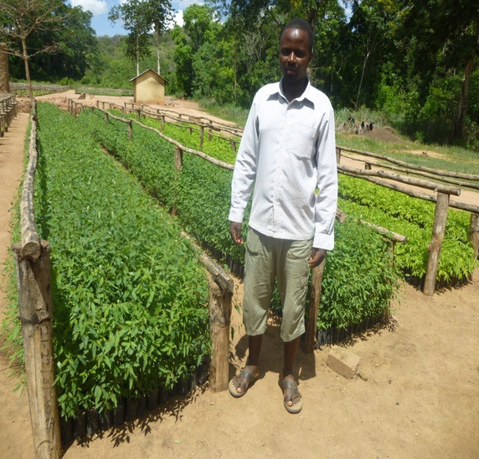 a man posing at Rondo tree planting project, African Palms