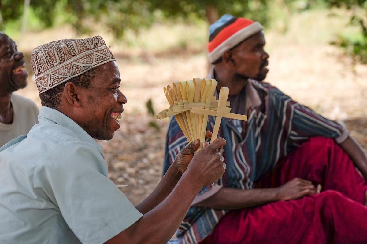 People from Tanzania making handwoven palm crosses