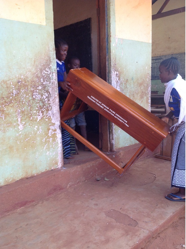 taking the desks into school for Masasi Villages project  funded by African Palms selling palm crosses