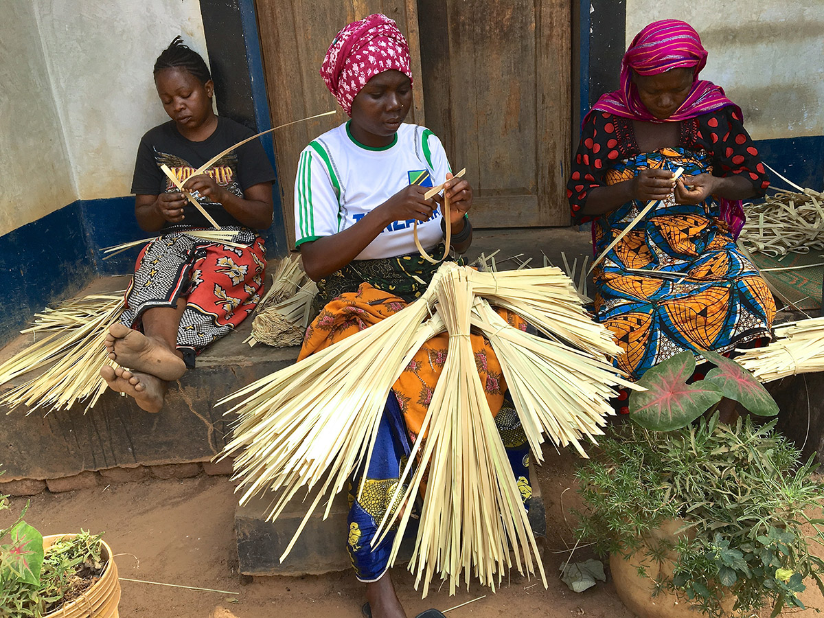 Group of women at Masasi village handwoven palm crosses