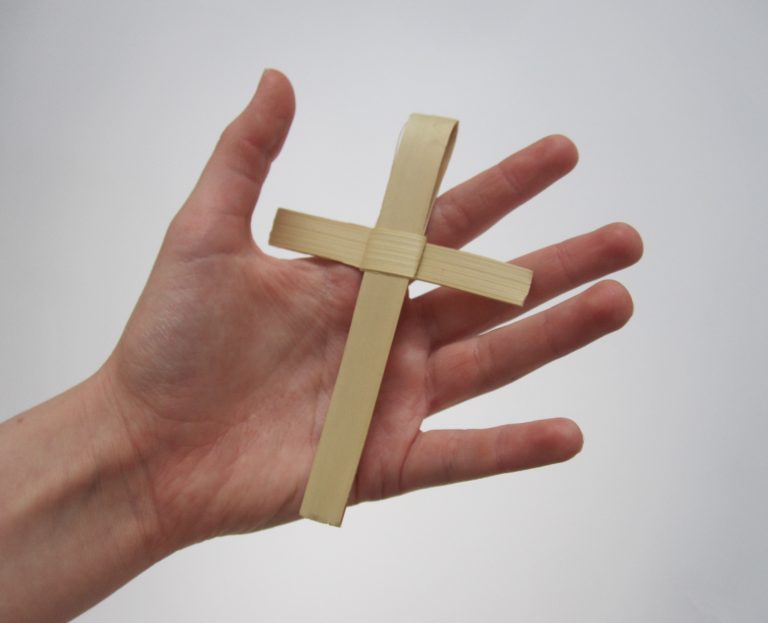 African Palm Cross, small size - handwoven palm cross holding by hand